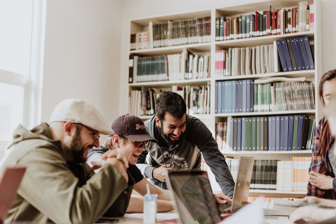 A group working together over laptops in a library